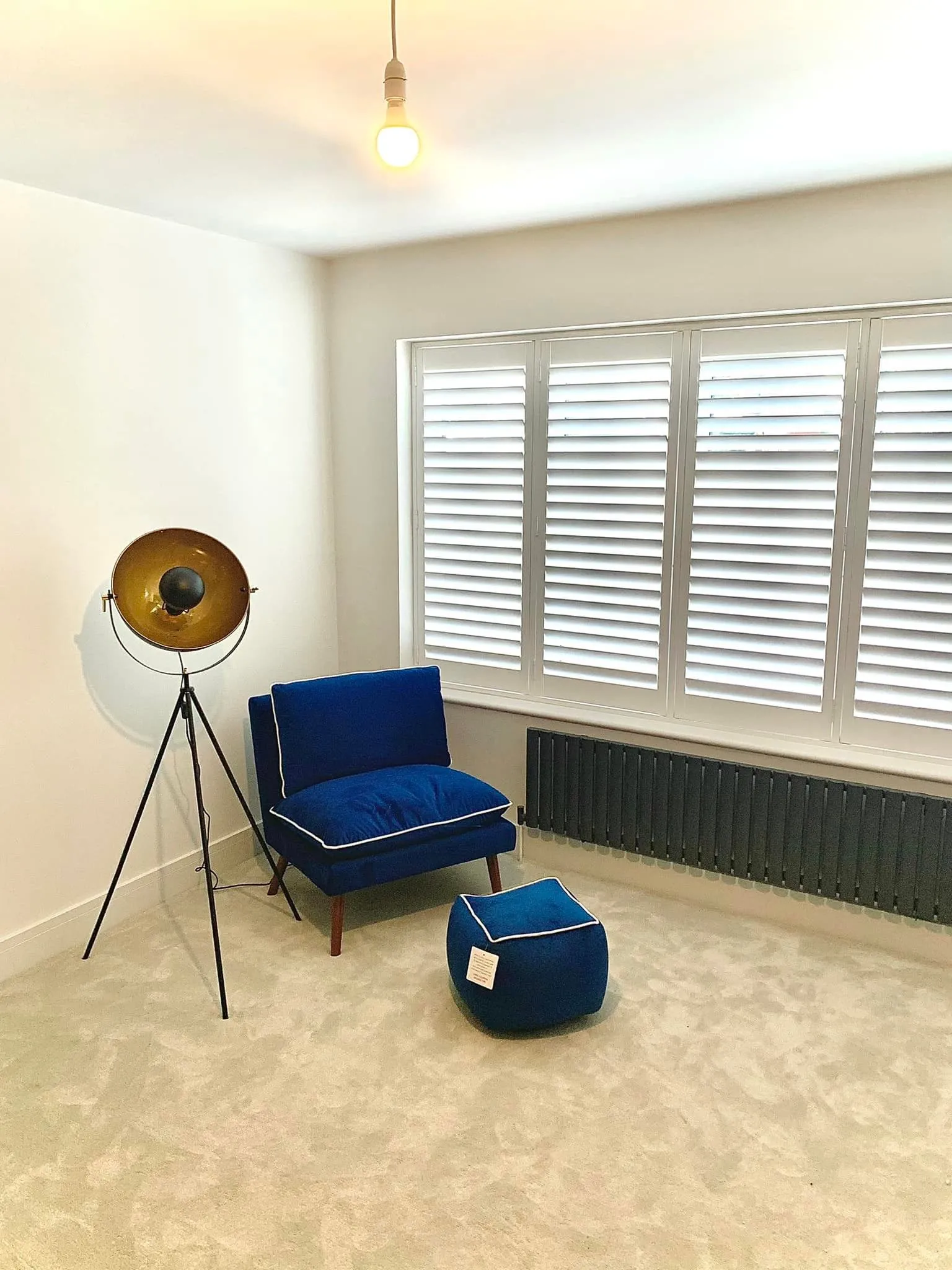 blue chair next to a window