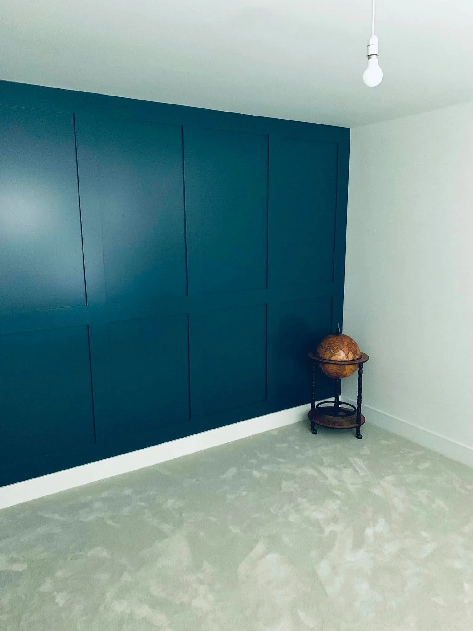 room with blue wall and globe